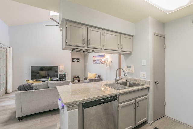 kitchen with gray cabinetry, light hardwood / wood-style floors, dishwasher, and sink