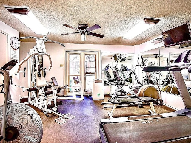 workout area featuring a ceiling fan, visible vents, and a textured ceiling