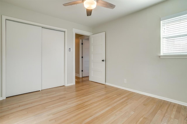 unfurnished bedroom featuring ceiling fan, a closet, and light hardwood / wood-style floors