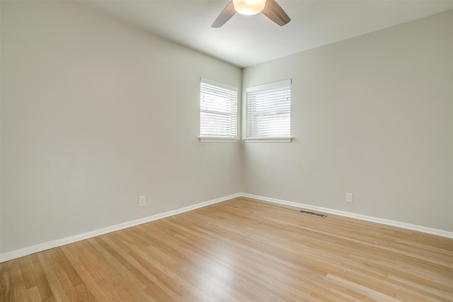 spare room with ceiling fan and light wood-type flooring