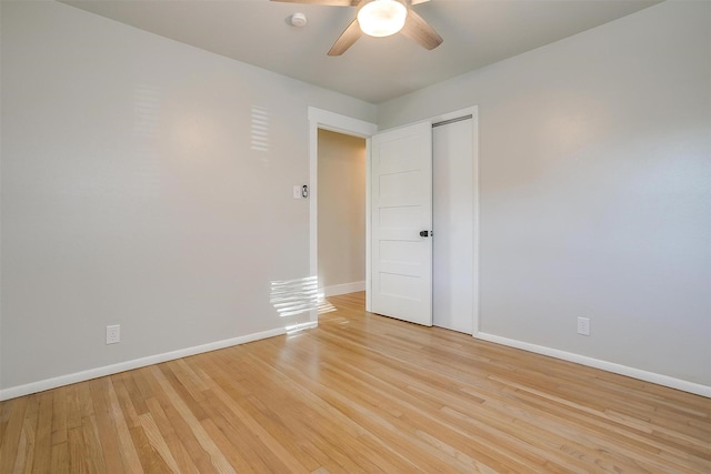 empty room featuring ceiling fan and light hardwood / wood-style flooring