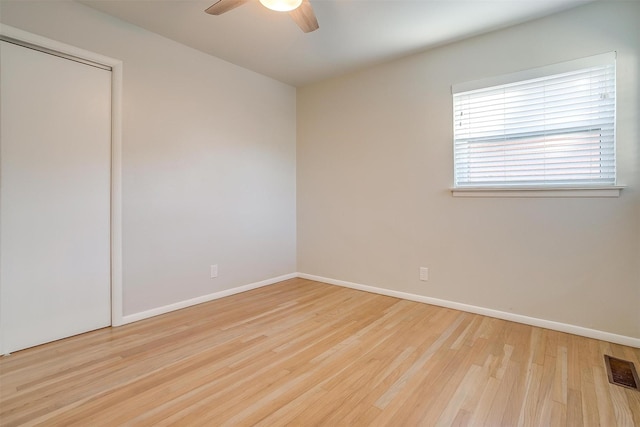 unfurnished room with light wood-type flooring and ceiling fan