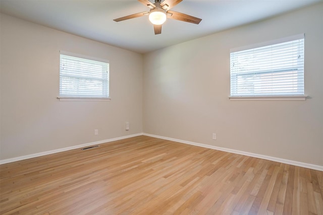 spare room with light wood-type flooring and ceiling fan