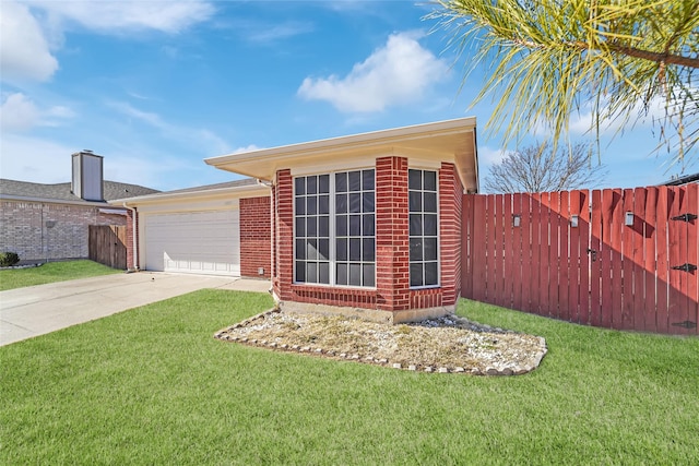 view of front of house featuring a garage and a front lawn