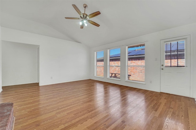 unfurnished living room with vaulted ceiling, light hardwood / wood-style floors, and ceiling fan