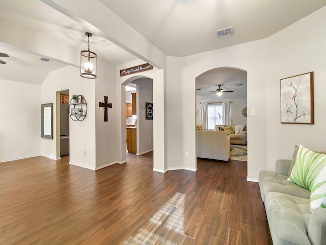 living room with ceiling fan and dark hardwood / wood-style flooring