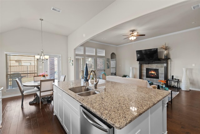 kitchen featuring white cabinetry, an island with sink, dishwasher, hanging light fixtures, and sink