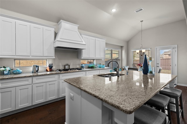 kitchen with sink, white cabinetry, a kitchen island with sink, and custom exhaust hood