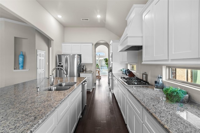 kitchen featuring premium range hood, stainless steel appliances, white cabinets, and sink