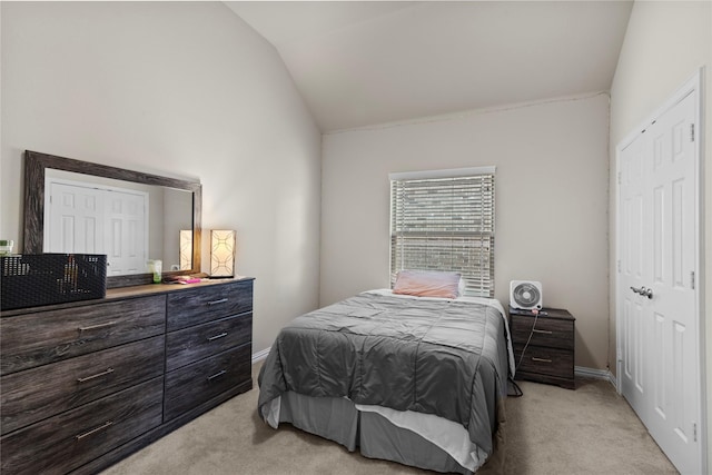 carpeted bedroom featuring lofted ceiling