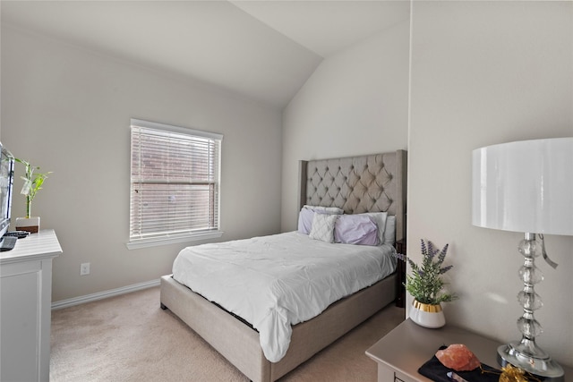 carpeted bedroom featuring lofted ceiling