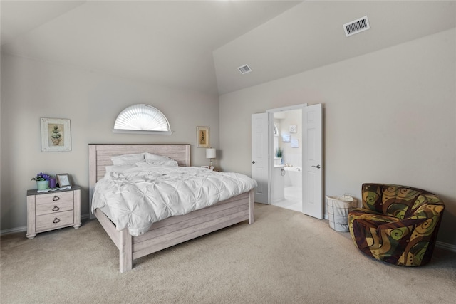 carpeted bedroom with ensuite bathroom and lofted ceiling