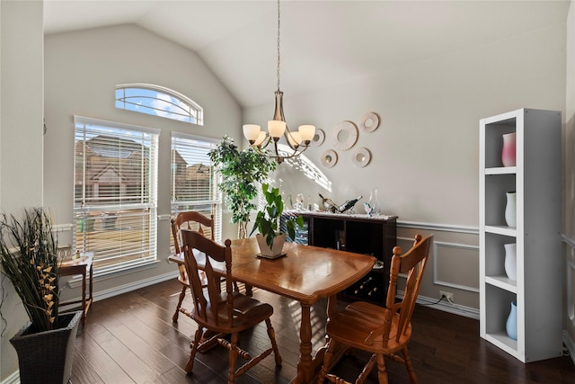 dining space featuring lofted ceiling, dark wood-type flooring, and a notable chandelier