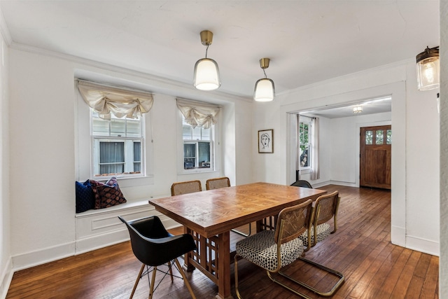 dining space featuring dark hardwood / wood-style flooring and crown molding