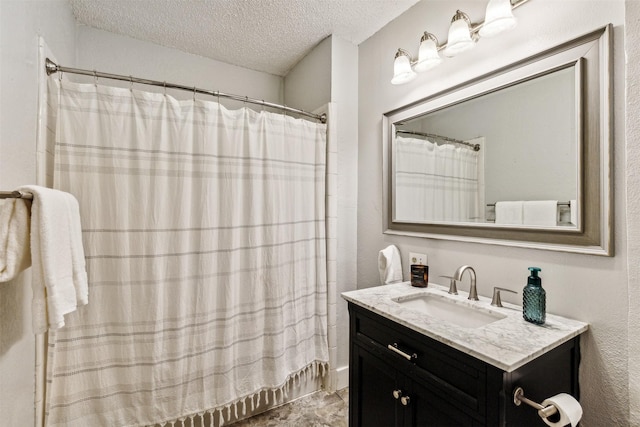 bathroom with a textured ceiling, a shower with shower curtain, and vanity