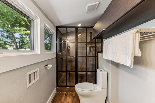 bathroom with plenty of natural light, hardwood / wood-style floors, and toilet