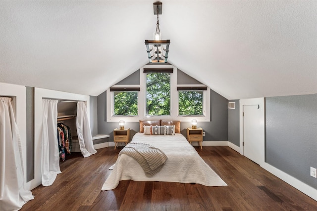 bedroom with dark hardwood / wood-style flooring and lofted ceiling