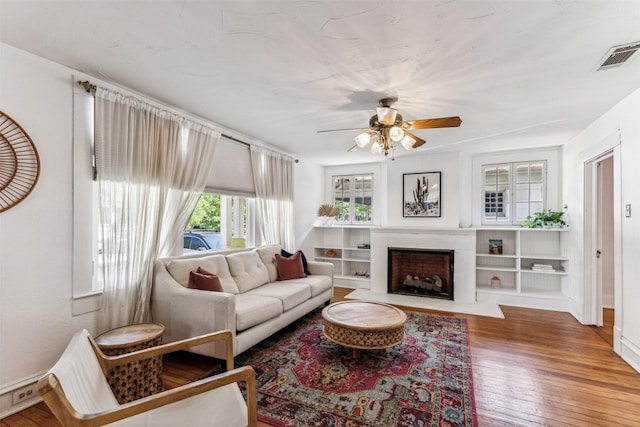 living room featuring ceiling fan and hardwood / wood-style floors