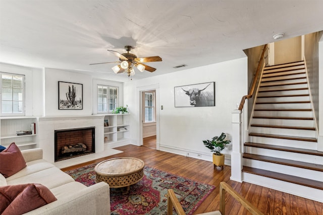 living room with ceiling fan and light hardwood / wood-style flooring