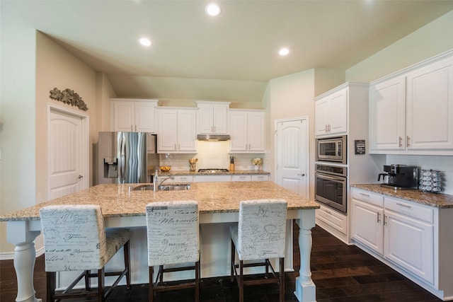 kitchen with a center island with sink, stainless steel appliances, white cabinetry, and sink