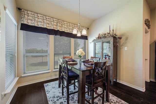 dining room featuring dark hardwood / wood-style floors, a notable chandelier, and vaulted ceiling