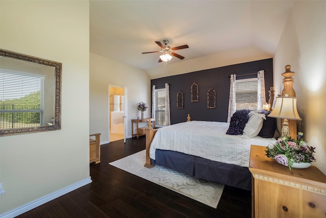 bedroom with dark wood-type flooring, ceiling fan, ensuite bathroom, and vaulted ceiling