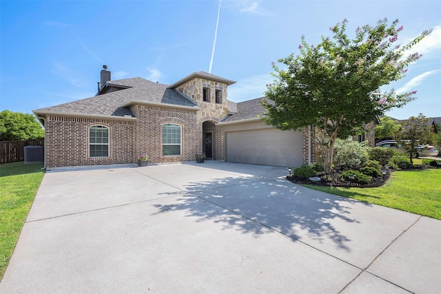 view of front facade with a garage and a front lawn