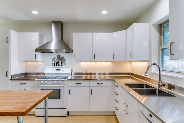 kitchen with stainless steel counters, wall chimney exhaust hood, white appliances, and white cabinetry