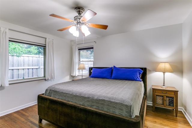 bedroom with ceiling fan and wood-type flooring