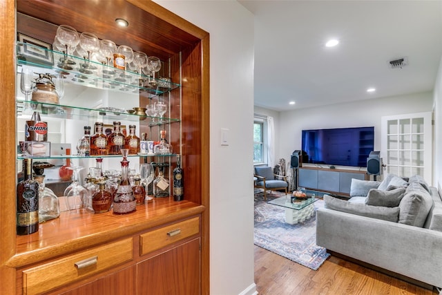 bar featuring light hardwood / wood-style floors