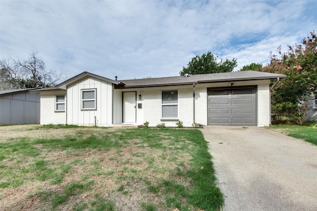 ranch-style house with a garage and a front yard