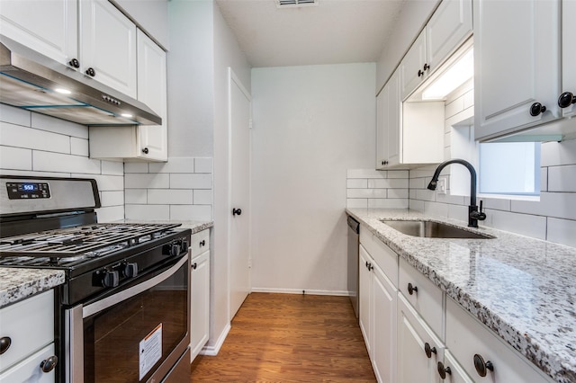 kitchen with sink, backsplash, white cabinets, and stainless steel appliances