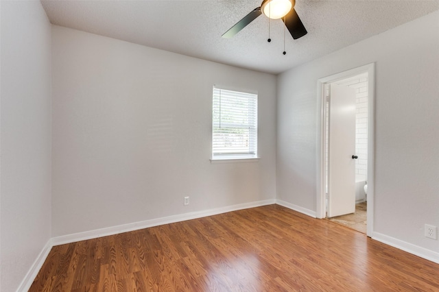 spare room with ceiling fan, hardwood / wood-style floors, and a textured ceiling