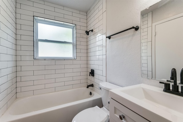 full bathroom featuring tiled shower / bath combo, vanity, and toilet