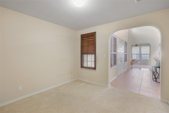 spare room featuring light carpet