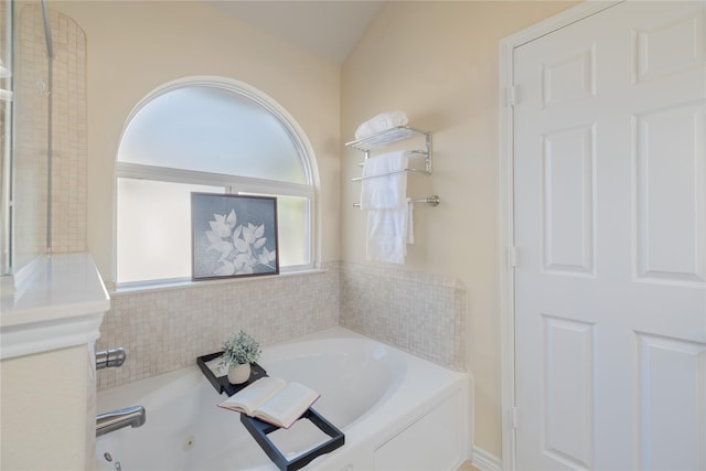 bathroom featuring plenty of natural light and a bathing tub