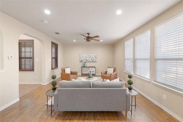 living room featuring ceiling fan and light wood-type flooring