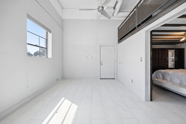 bedroom with ceiling fan and beam ceiling