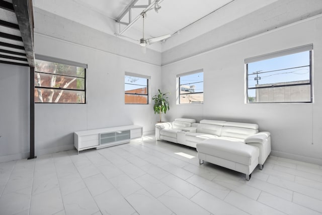 living room with a healthy amount of sunlight and a towering ceiling