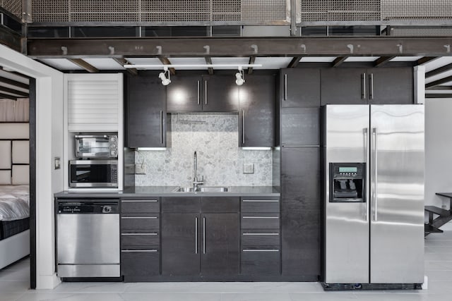 kitchen featuring appliances with stainless steel finishes, backsplash, and sink