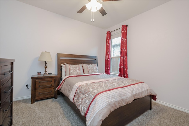 bedroom with ceiling fan and light carpet