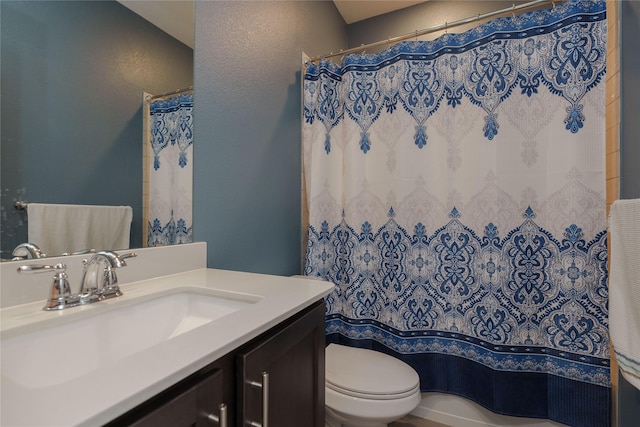 bathroom with toilet, vanity, and a shower with shower curtain