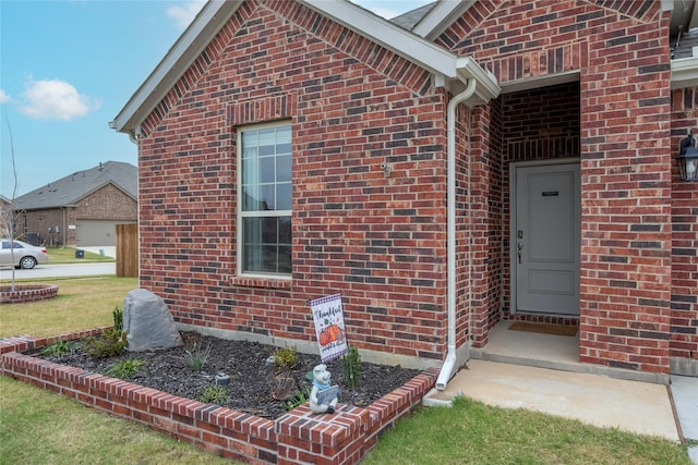 entrance to property featuring a lawn