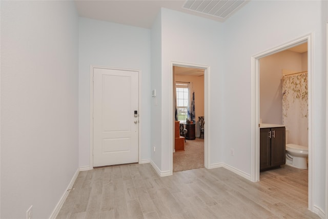 hallway with light hardwood / wood-style flooring