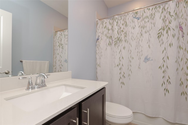 bathroom featuring toilet and vanity