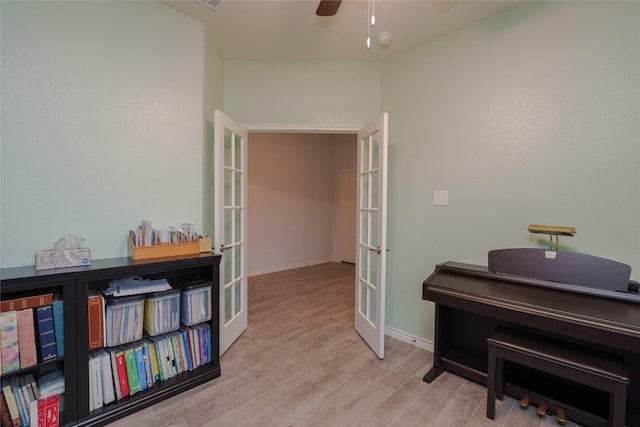 misc room featuring ceiling fan, french doors, and light hardwood / wood-style flooring