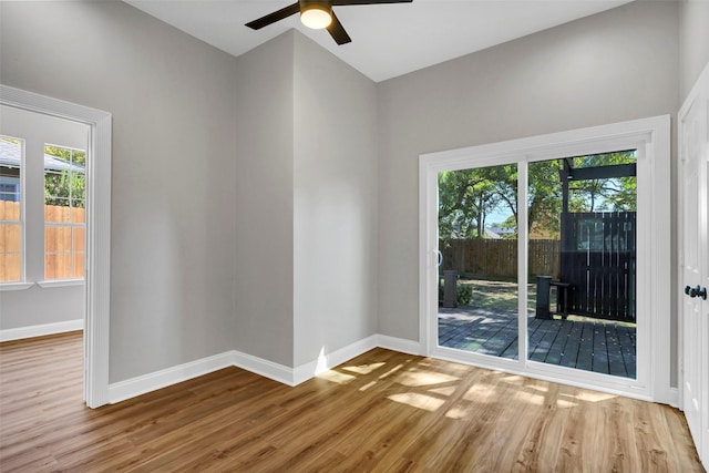 unfurnished room featuring ceiling fan, a healthy amount of sunlight, and hardwood / wood-style flooring