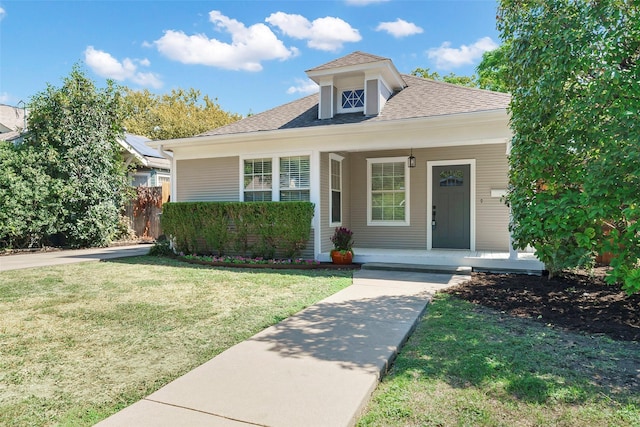 view of front of property with covered porch and a front yard