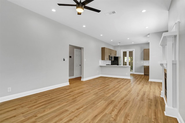 unfurnished living room featuring ceiling fan and light hardwood / wood-style flooring