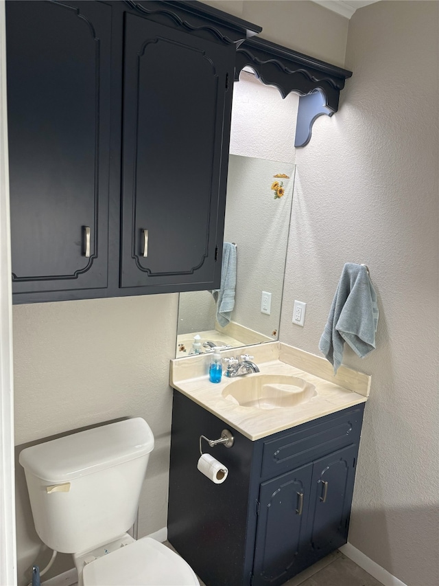 bathroom featuring toilet and vanity